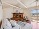 Bright living room with a brick fireplace, a sliding glass door, and neutral furniture at 13640 W Center Dr, Lakewood, CO 80228