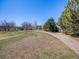 Pathway through a park with mature trees, playground and green space at 13640 W Center Dr, Lakewood, CO 80228