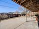 Covered patio with concrete flooring, offering shade and protection for outdoor gatherings and activities at 13640 W Center Dr, Lakewood, CO 80228