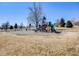 Outdoor playground for children includes slides, climbing features, and swings at 13640 W Center Dr, Lakewood, CO 80228