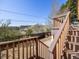 Wooden stairs leading to a deck with scenic hillside views, blending nature and home seamlessly at 13640 W Center Dr, Lakewood, CO 80228