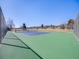 Outdoor tennis court surrounded by a chain-link fence at 13640 W Center Dr, Lakewood, CO 80228