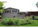 Exterior view of the home showcasing lush gardens and an outdoor patio at 6864 Balsam St, Arvada, CO 80004