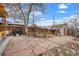 Spacious backyard featuring stone patio, gazebo, and a rustic wooden fence at 6864 Balsam St, Arvada, CO 80004