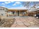 Large backyard with a covered patio, a stone pathway, and mature landscaping at 6864 Balsam St, Arvada, CO 80004