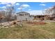 Expansive backyard with lush lawn, patio, and covered deck, perfect for outdoor entertaining at 6864 Balsam St, Arvada, CO 80004