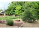 A charming backyard features a fire pit, lush greenery and landscaping, creating a cozy outdoor retreat at 6864 Balsam St, Arvada, CO 80004