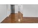 Finished basement with hardwood floors and neutral wall color at 6864 Balsam St, Arvada, CO 80004