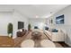 Staged basement living area with furniture, TV and decor at 6864 Balsam St, Arvada, CO 80004