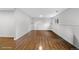 Unfurnished basement with hardwood floors and white paneling at 6864 Balsam St, Arvada, CO 80004