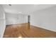 Empty basement space featuring hardwood floors and white walls at 6864 Balsam St, Arvada, CO 80004