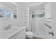 Stylish bathroom featuring white shiplap and a standing shower with blue tile accents at 6864 Balsam St, Arvada, CO 80004