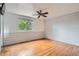 Bedroom with hardwood floors, ceiling fan, and horizontal shiplap accent wall at 6864 Balsam St, Arvada, CO 80004