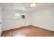 Bright bedroom with hardwood floors and plenty of natural light at 6864 Balsam St, Arvada, CO 80004