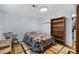 Cozy bedroom features a vintage bed and a bookshelf for storage at 6864 Balsam St, Arvada, CO 80004