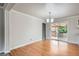 Bright dining room featuring a hardwood floor, white trim, and access to an outdoor patio at 6864 Balsam St, Arvada, CO 80004
