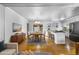 Open concept dining room and kitchen with stainless steel appliances and hardwood floors throughout at 6864 Balsam St, Arvada, CO 80004