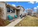 Inviting home exterior showcasing two blue chairs on the front porch and well-manicured landscaping at 6864 Balsam St, Arvada, CO 80004