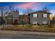 Charming two-story home with a well-maintained lawn and a detached garage, showcasing curb appeal at 6864 Balsam St, Arvada, CO 80004