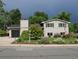 Charming two-story home featuring manicured landscaping and a black two car garage at 6864 Balsam St, Arvada, CO 80004
