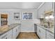 Contemporary kitchen with granite countertops, stainless steel appliances, tile backsplash and tile flooring at 6864 Balsam St, Arvada, CO 80004