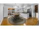 Bright kitchen and dining area, featuring hardwood floors, stainless steel appliances, and sliding door access to deck at 6864 Balsam St, Arvada, CO 80004