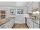 Well-lit kitchen featuring granite counters, stainless steel appliances, and neutral color palette at 6864 Balsam St, Arvada, CO 80004