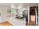 Bright kitchen featuring stone countertops, stainless steel appliances, and hardwood floors at 6864 Balsam St, Arvada, CO 80004