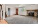 Bright living room with hardwood floors, a fireplace, and large windows that let in natural light at 6864 Balsam St, Arvada, CO 80004