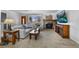 Cozy living room with a stone fireplace, neutral carpet and a large window for plenty of natural light at 6864 Balsam St, Arvada, CO 80004