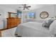 Sunlit main bedroom with wood accent wall, featuring a ceiling fan and large closet at 6864 Balsam St, Arvada, CO 80004
