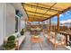 Spacious patio with a covered area, string lights, and comfortable outdoor furniture at 6864 Balsam St, Arvada, CO 80004