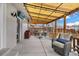 Covered patio with string lights, outdoor seating, and a mounted TV for entertaining at 6864 Balsam St, Arvada, CO 80004