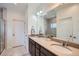 Bright bathroom with double vanity, large mirror, and tiled floors at 11270 E 26Th Ave, Aurora, CO 80010