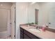 Bathroom featuring a modern vanity, large mirror, and a shower/tub combination with tiled walls at 11270 E 26Th Ave, Aurora, CO 80010