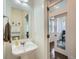 Stylish half bath with pedestal sink next to doorway to study room at 11270 E 26Th Ave, Aurora, CO 80010