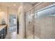 Beautiful bathroom with tiled shower behind glass door and marble floors at 11270 E 26Th Ave, Aurora, CO 80010