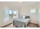 Sun-lit bedroom featuring a window with sheer curtains and a large view at 11270 E 26Th Ave, Aurora, CO 80010