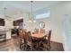 Elegant dining room featuring a wooden table, chandelier, and seamless access to the kitchen at 11270 E 26Th Ave, Aurora, CO 80010