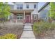 Inviting front exterior with a cozy porch, brick detailing, and a charming wreath on the front door at 11270 E 26Th Ave, Aurora, CO 80010