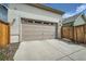 Attached two-car garage with an automatic door and a driveway at 11270 E 26Th Ave, Aurora, CO 80010