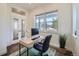 Bright home office with a modern desk, comfortable chair, and plenty of natural light from the windows at 11270 E 26Th Ave, Aurora, CO 80010