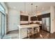 Modern kitchen with stainless steel appliances, a central island, and stylish pendant lighting at 11270 E 26Th Ave, Aurora, CO 80010