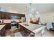 Modern kitchen with stainless steel appliances, large island, and dark wood cabinets at 11270 E 26Th Ave, Aurora, CO 80010