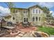 Backyard of home with patio, seating, fire pit, water feature, and landscaped yard at 25 Summit Ash, Littleton, CO 80127