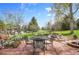 Inviting brick patio with outdoor seating and a beautifully landscaped backyard, perfect for entertaining at 25 Summit Ash, Littleton, CO 80127