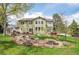 A serene backyard featuring a tranquil water feature, a patio, and mature trees at 25 Summit Ash, Littleton, CO 80127