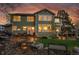 Expansive backyard with a brick patio, a cozy firepit, lush lawn, and a tranquil water feature at 25 Summit Ash, Littleton, CO 80127