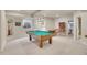 Basement game room featuring a pool table, pinball machine, and updated lighting at 25 Summit Ash, Littleton, CO 80127