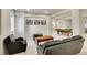 Relaxing basement with black leather seating, coffee table, and pool table in background at 25 Summit Ash, Littleton, CO 80127